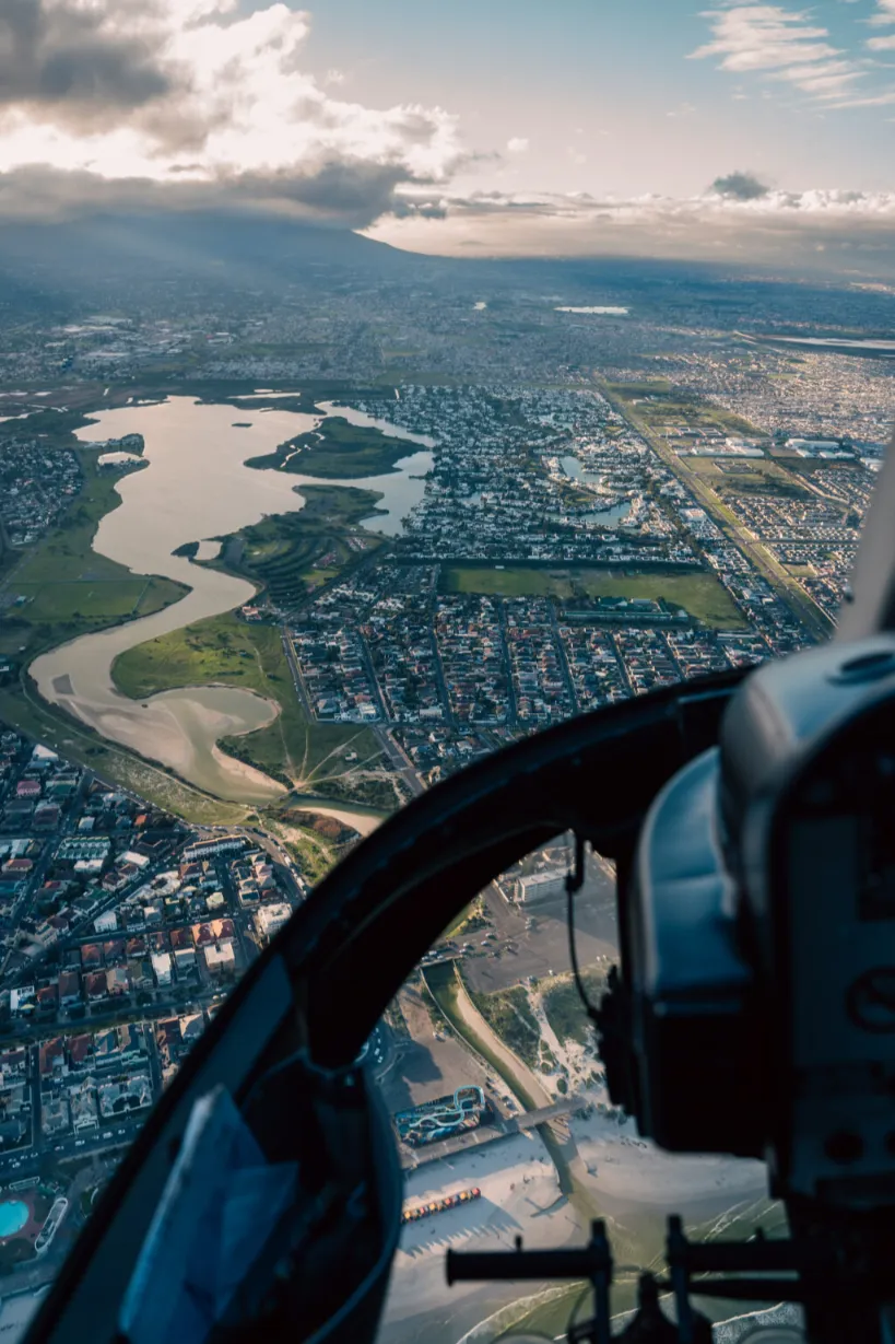 View from an NAC helicopter cabin over the wetlands and suburbs of Cape Town